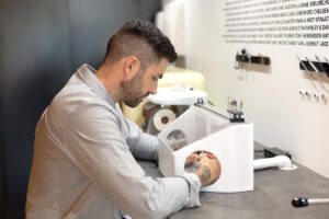 Ocularist Dwayne Collins crafting a patients prosthetic eye.