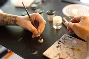 Oculus Prosthetics Ocularist hand painting a prosthetic eye.